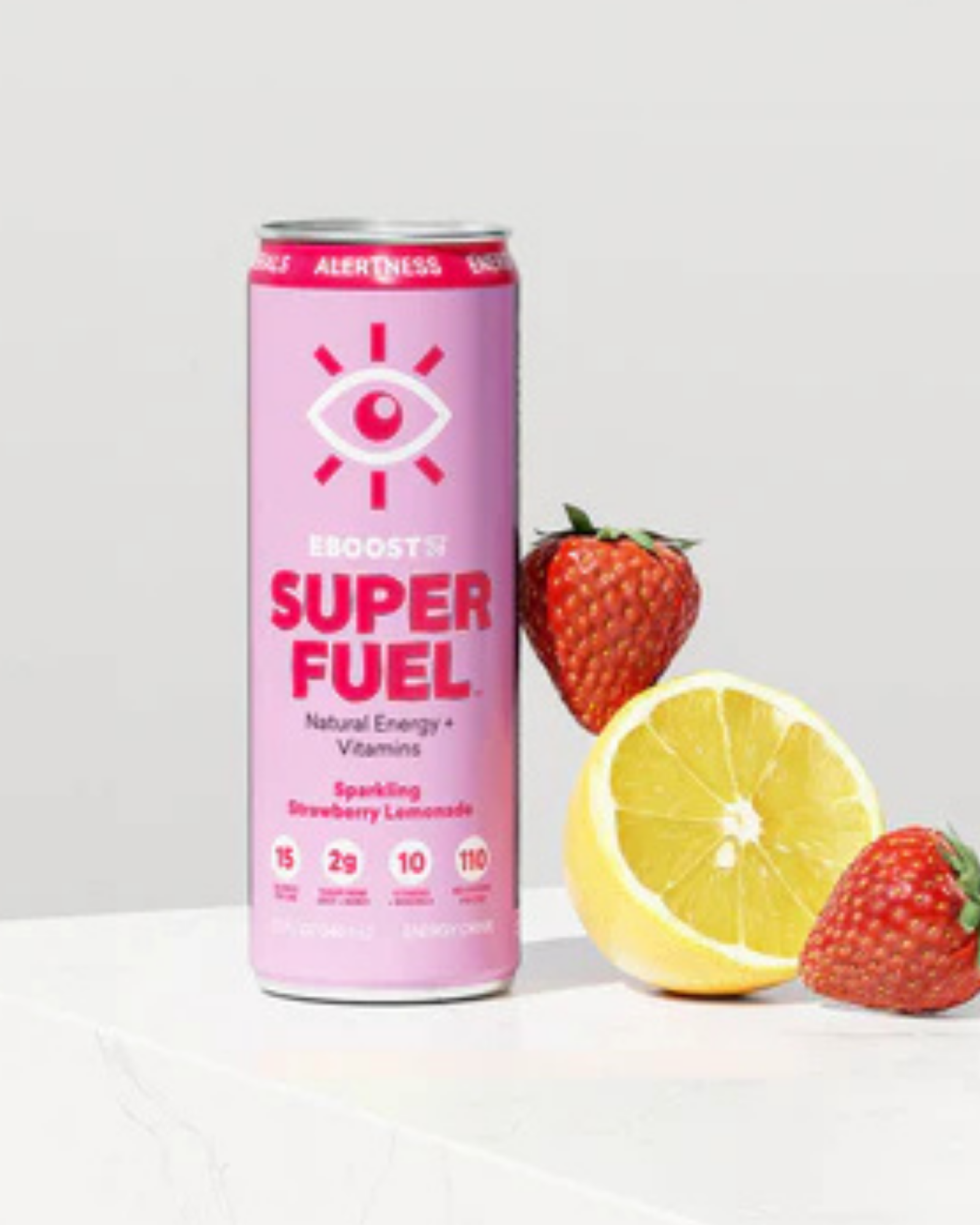 Editorial product shot of EBOOST Super Fuel sparkling pink can with strawberries and a sliced lemon